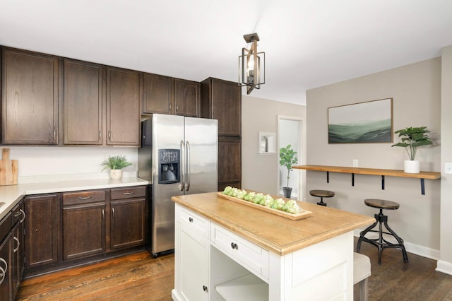 333 3rd St NE, Osseo, MN 55369 - kitchen featuring stainless steel fridge with ice dispenser, dark wood-style flooring, dark brown cabinets, decorative light fixtures, and wooden counters