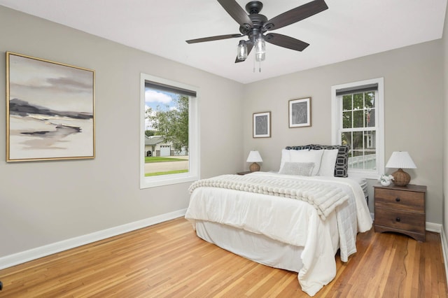 333 3rd St NE, Osseo, MN 55369 - bedroom featuring multiple windows, light wood-style flooring, and ceiling fan