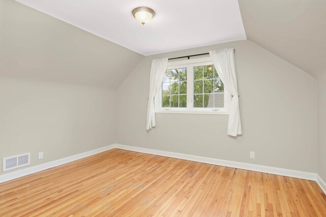 333 3rd St NE, Osseo, MN 55369 - additional living space with lofted ceiling and hardwood / wood-style floors