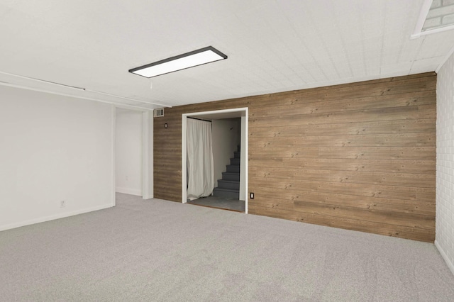333 3rd St NE, Osseo, MN 55369 - unfurnished room featuring wooden walls, stairs, and carpet