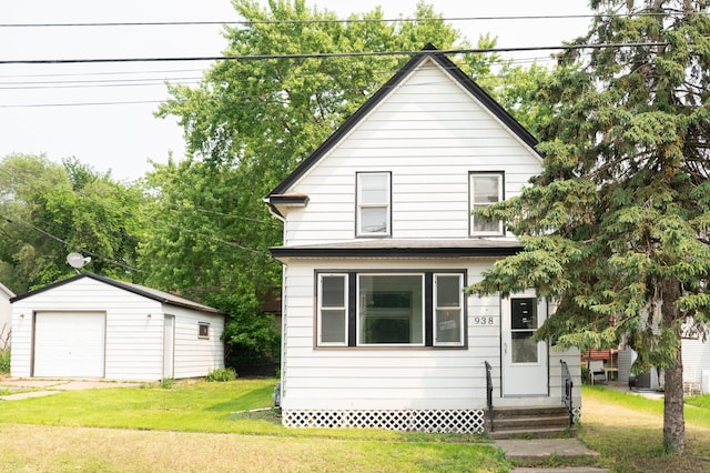 938 Cypress St, Saint Paul, MN 55106 - view of front of home with an outdoor structure, a detached garage, a front yard, and entry steps