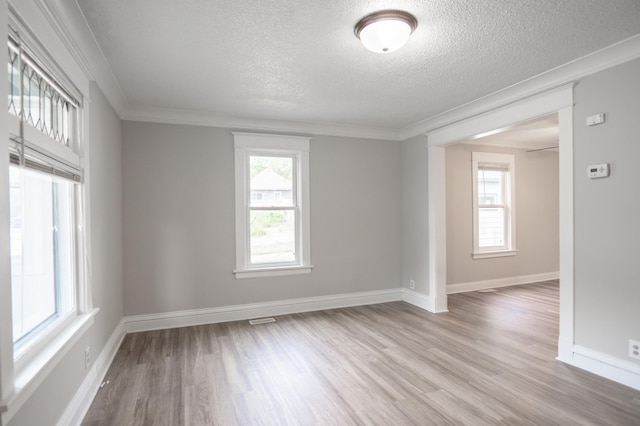 938 Cypress St, Saint Paul, MN 55106 - unfurnished room with light wood-style flooring, healthy amount of natural light, a textured ceiling, and ornamental molding