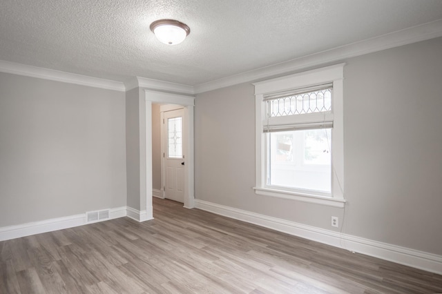 938 Cypress St, Saint Paul, MN 55106 - unfurnished room with a textured ceiling, wood finished floors, and crown molding