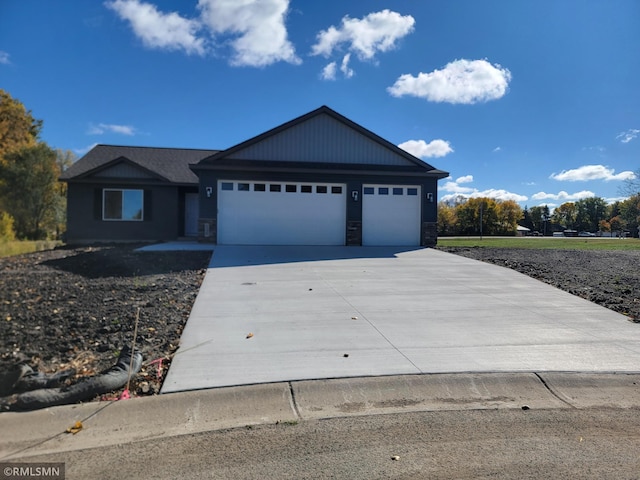 217 Bouldercrest Ave NE, Owatonna, MN 55060 - single story home with a garage, driveway, and stone siding