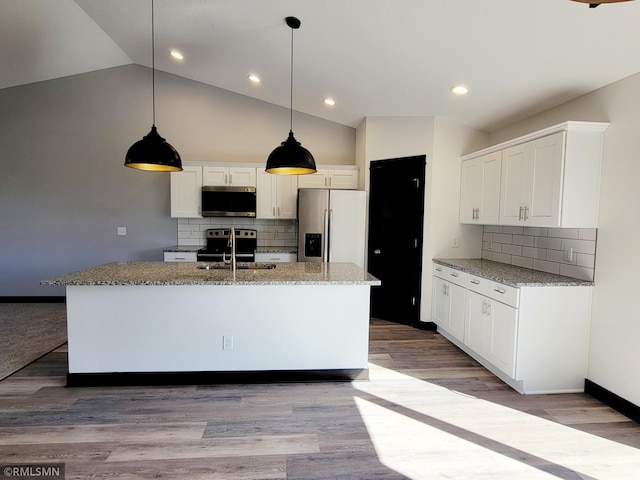 217 Bouldercrest Ave NE, Owatonna, MN 55060 - kitchen featuring stainless steel appliances, backsplash, white cabinetry, light stone countertops, and lofted ceiling