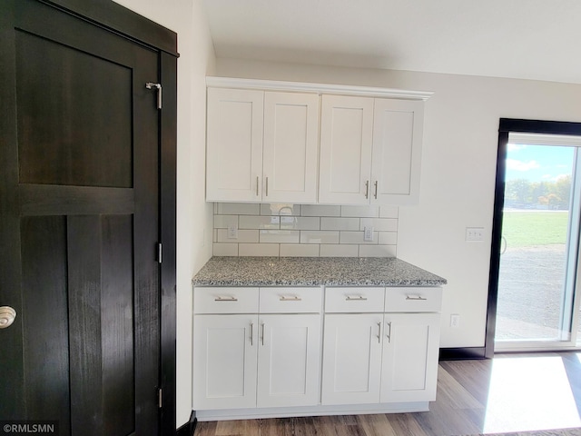 217 Bouldercrest Ave NE, Owatonna, MN 55060 - kitchen featuring light wood-style flooring, light stone counters, tasteful backsplash, and white cabinets