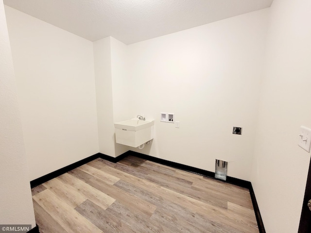 217 Bouldercrest Ave NE, Owatonna, MN 55060 - washroom featuring wood finished floors and washer hookup