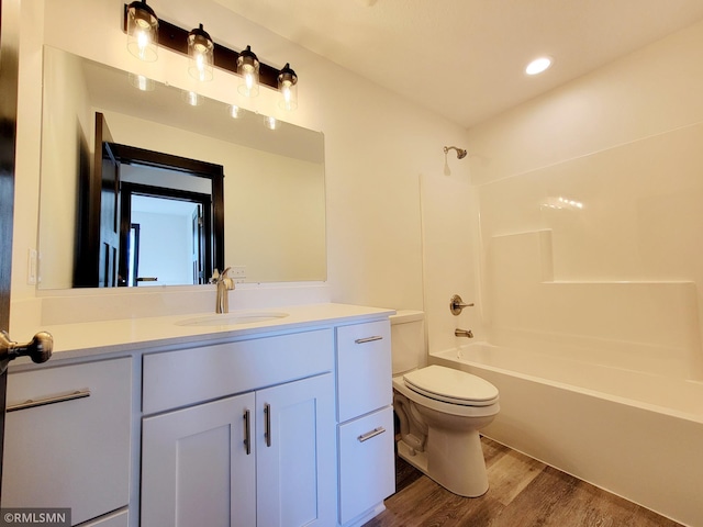 217 Bouldercrest Ave NE, Owatonna, MN 55060 - bathroom featuring vanity, wood finished floors, shower / tub combination, and recessed lighting