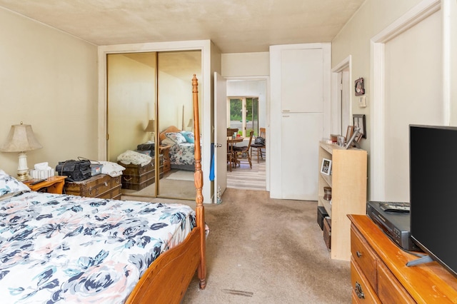 bedroom with light colored carpet and a closet