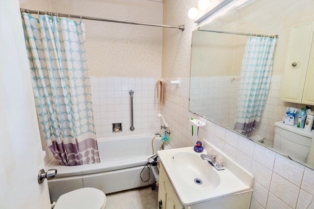 full bathroom with tile walls, vanity, and shower / bath combination with curtain