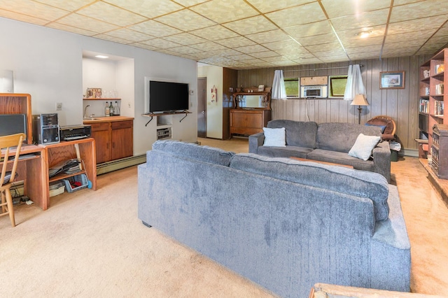 living area featuring light carpet, a baseboard radiator, wooden walls, and cooling unit