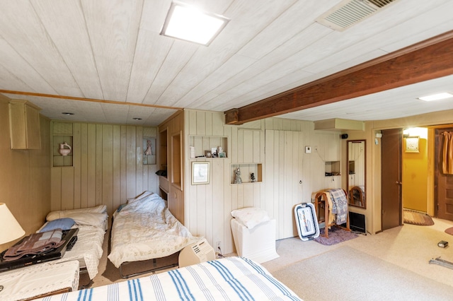 bedroom with wood walls, wood ceiling, and carpet floors