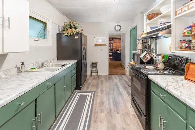 kitchen featuring black appliances, green cabinets, light wood-type flooring, under cabinet range hood, and light countertops