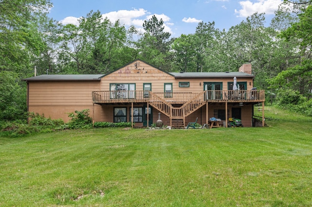 rear view of property with a chimney, a wooden deck, a yard, and stairs