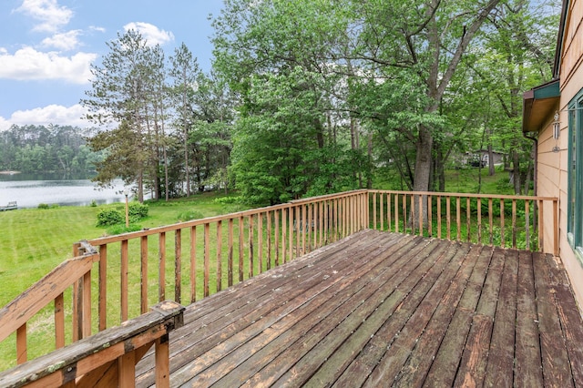 deck featuring a water view and a lawn