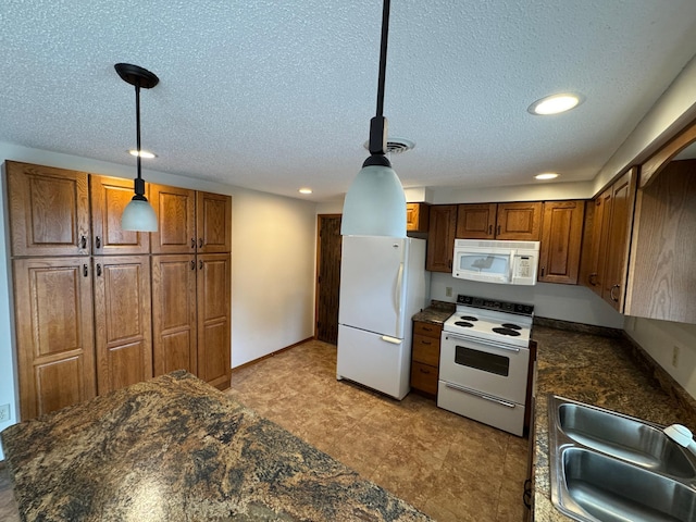 1572 County Road 4, Island Lake Twp, MN 56157 - kitchen featuring white appliances, dark countertops, recessed lighting, brown cabinetry, and pendant lighting