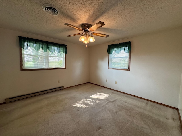 1572 County Road 4, Island Lake Twp, MN 56157 - spare room featuring baseboard heating, healthy amount of natural light, light carpet, ceiling fan, and a textured ceiling