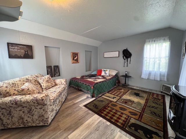 36434 145th Ave, Blueberry Twp, MN 56464 - bedroom with lofted ceiling, wood finished floors, and a textured ceiling