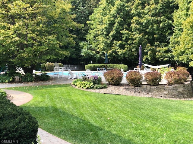 4022 Hillcrest Rd, Deephaven, MN 55391 - view of yard featuring an outdoor pool and a view of trees