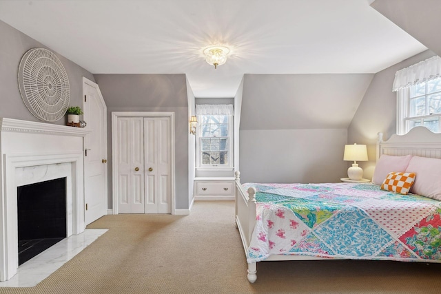 4022 Hillcrest Rd, Deephaven, MN 55391 - carpeted bedroom with a high end fireplace, vaulted ceiling, and a closet