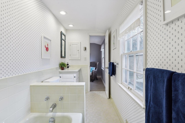 4022 Hillcrest Rd, Deephaven, MN 55391 - full bathroom with a garden tub, tile patterned floors, vanity, wallpapered walls, and vaulted ceiling