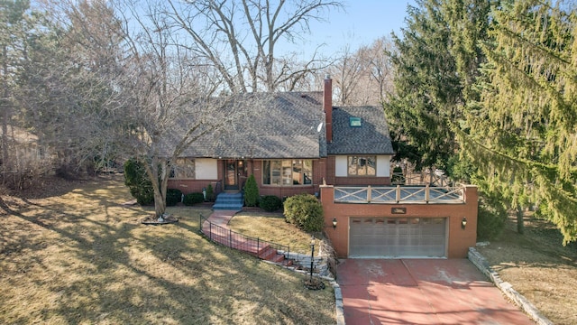 2905 Lake Blvd N, Saint Paul, MN 55109 - tudor home with concrete driveway, brick siding, a garage, and a front lawn