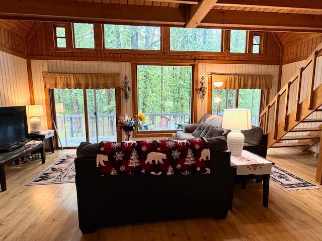 42863 270th St, Malung Twp, MN 56751 - living area featuring wood walls, stairway, beamed ceiling, healthy amount of natural light, and wood finished floors