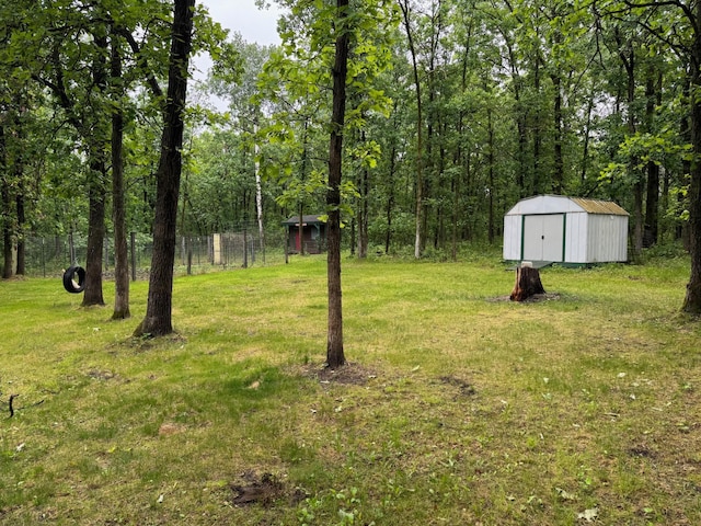 42863 270th St, Malung Twp, MN 56751 - view of grassy yard with a shed and a forest view