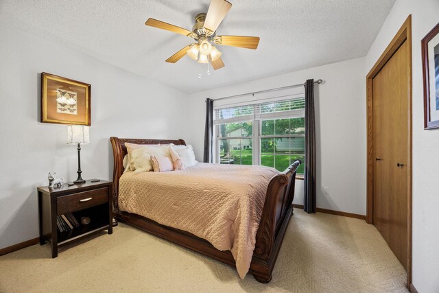 119 Morningside Dr NE, Hutchinson, MN 55350 - bedroom featuring light colored carpet, a textured ceiling, and ceiling fan