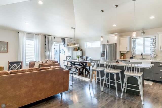 7339 21st St S, Fargo, ND 58104 - kitchen featuring stainless steel fridge with ice dispenser, a kitchen breakfast bar, open floor plan, a kitchen island, and pendant lighting