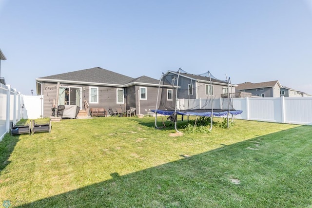7339 21st St S, Fargo, ND 58104 - rear view of property featuring a trampoline and a fenced backyard