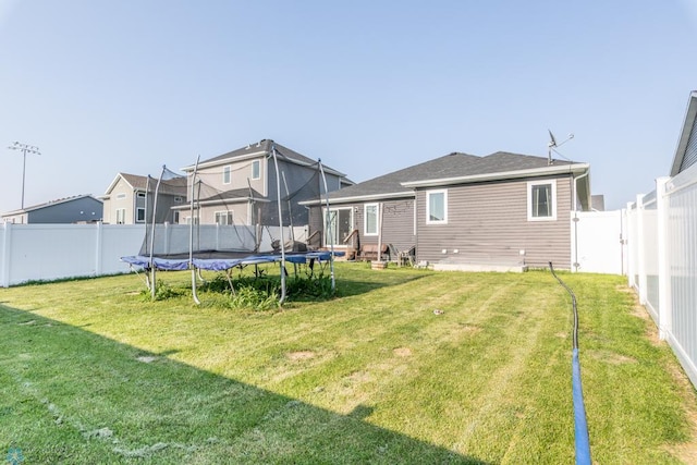 7339 21st St S, Fargo, ND 58104 - rear view of property with a trampoline and a fenced backyard