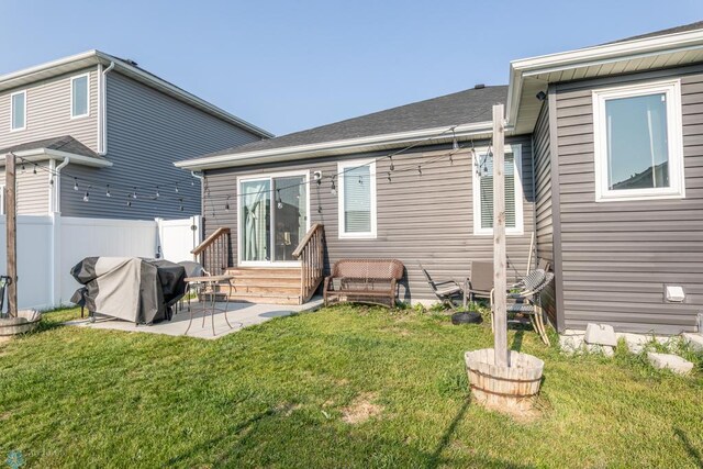 7339 21st St S, Fargo, ND 58104 - back of property with entry steps, a patio area, and a shingled roof