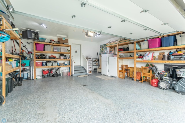 7339 21st St S, Fargo, ND 58104 - garage featuring a garage door opener and freestanding refrigerator