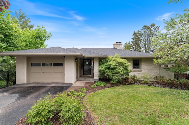 2514 Branch St, Duluth, MN 55812 - view of front facade featuring an attached garage, a chimney, asphalt driveway, and stucco siding