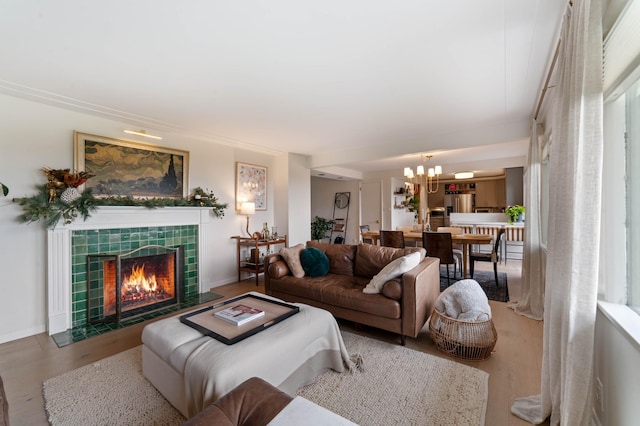 2514 Branch St, Duluth, MN 55812 - living room with a chandelier, a tiled fireplace, and wood finished floors