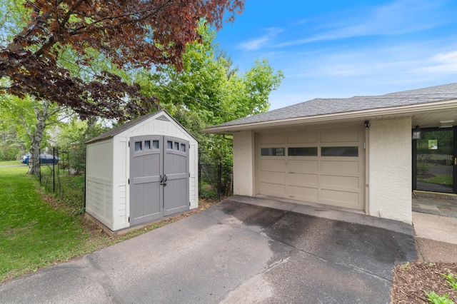 2514 Branch St, Duluth, MN 55812 - garage featuring a storage unit and asphalt driveway