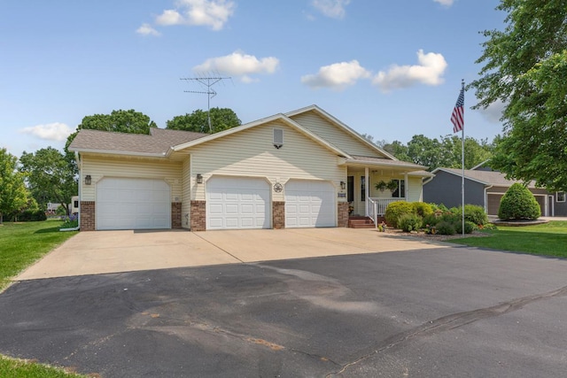 4820 Echo Ct, Faribault, MN 55021 - view of front of house with a garage, driveway, brick siding, a porch, and a front lawn