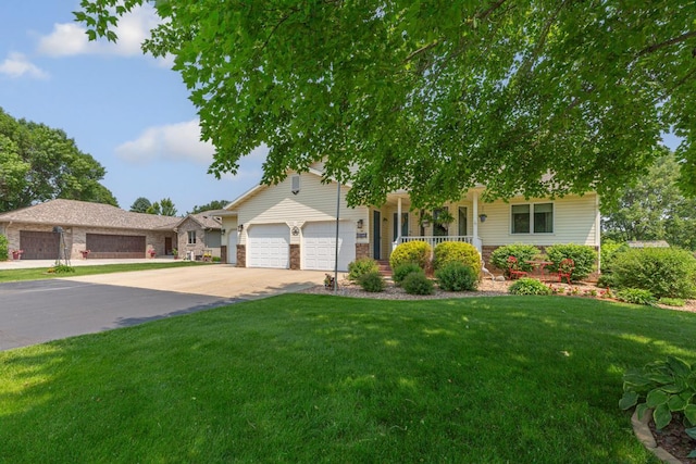 4820 Echo Ct, Faribault, MN 55021 - view of front of property with a garage, covered porch, concrete driveway, a front lawn, and brick siding