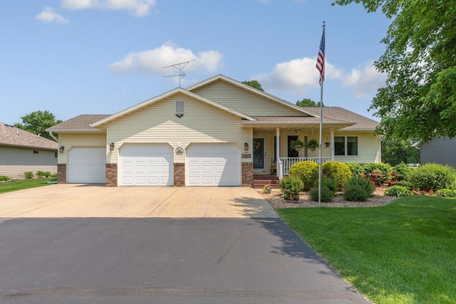4820 Echo Ct, Faribault, MN 55021 - view of front facade with an attached garage, driveway, a front yard, a porch, and brick siding