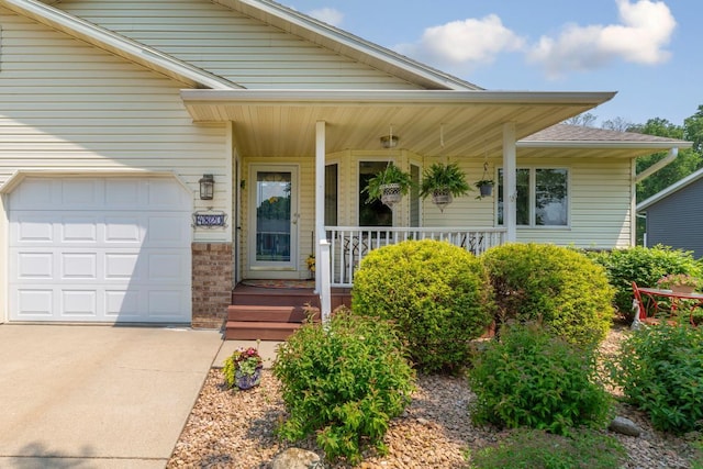 4820 Echo Ct, Faribault, MN 55021 - view of front of house with covered porch, concrete driveway, and a garage