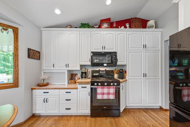 4820 Echo Ct, Faribault, MN 55021 - kitchen with black microwave, gas stove, lofted ceiling, a textured ceiling, and white cabinetry