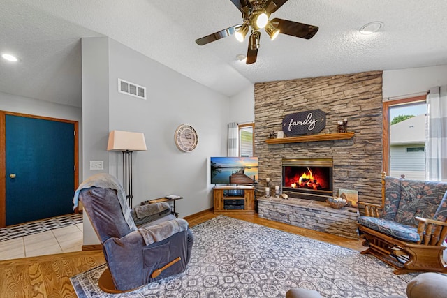 4820 Echo Ct, Faribault, MN 55021 - living area featuring a ceiling fan, a textured ceiling, a fireplace, vaulted ceiling, and wood finished floors