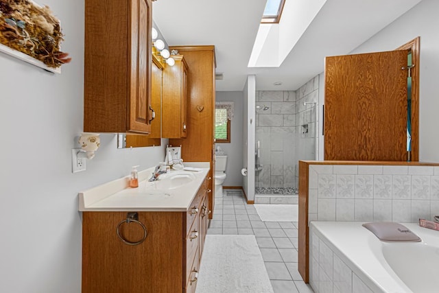 4820 Echo Ct, Faribault, MN 55021 - full bath featuring a skylight, vanity, a bath, a stall shower, and tile patterned floors