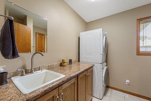 4820 Echo Ct, Faribault, MN 55021 - laundry room with stacked washer / drying machine, light tile patterned floors, and cabinet space