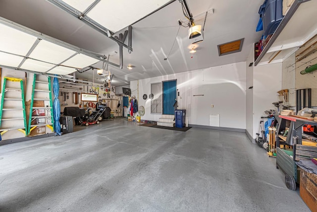 4820 Echo Ct, Faribault, MN 55021 - garage with a garage door opener and a workshop area