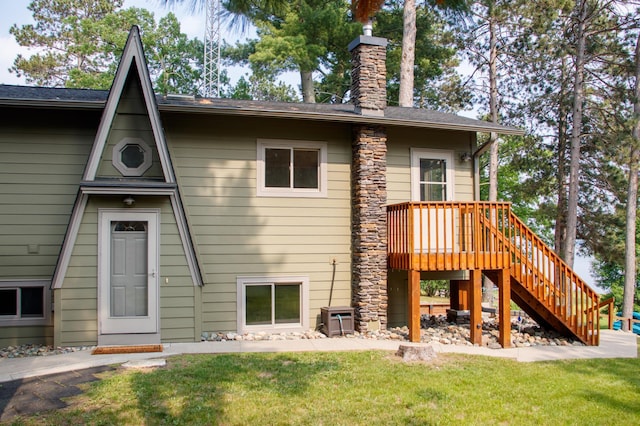 36945 Delta Bay Rd, Pine River, MN 56474 - back of house featuring a chimney, a yard, stairs, and a wooden deck
