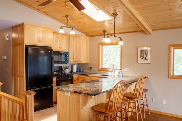 36945 Delta Bay Rd, Pine River, MN 56474 - kitchen with black appliances, light brown cabinetry, a peninsula, wooden ceiling, and a breakfast bar
