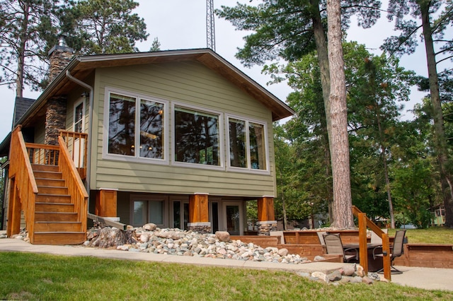 36945 Delta Bay Rd, Pine River, MN 56474 - view of front facade with stairs and a chimney