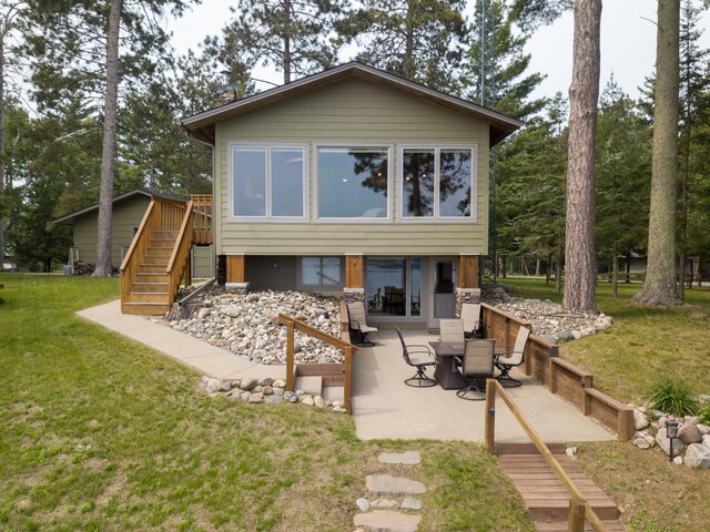 36945 Delta Bay Rd, Pine River, MN 56474 - back of house with stairway, a patio, and a lawn